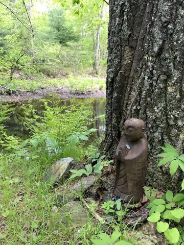 Jizo statue standing by the river
